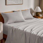 Flannel bed sheets and pillowcases on a bed in a bedroom setting.