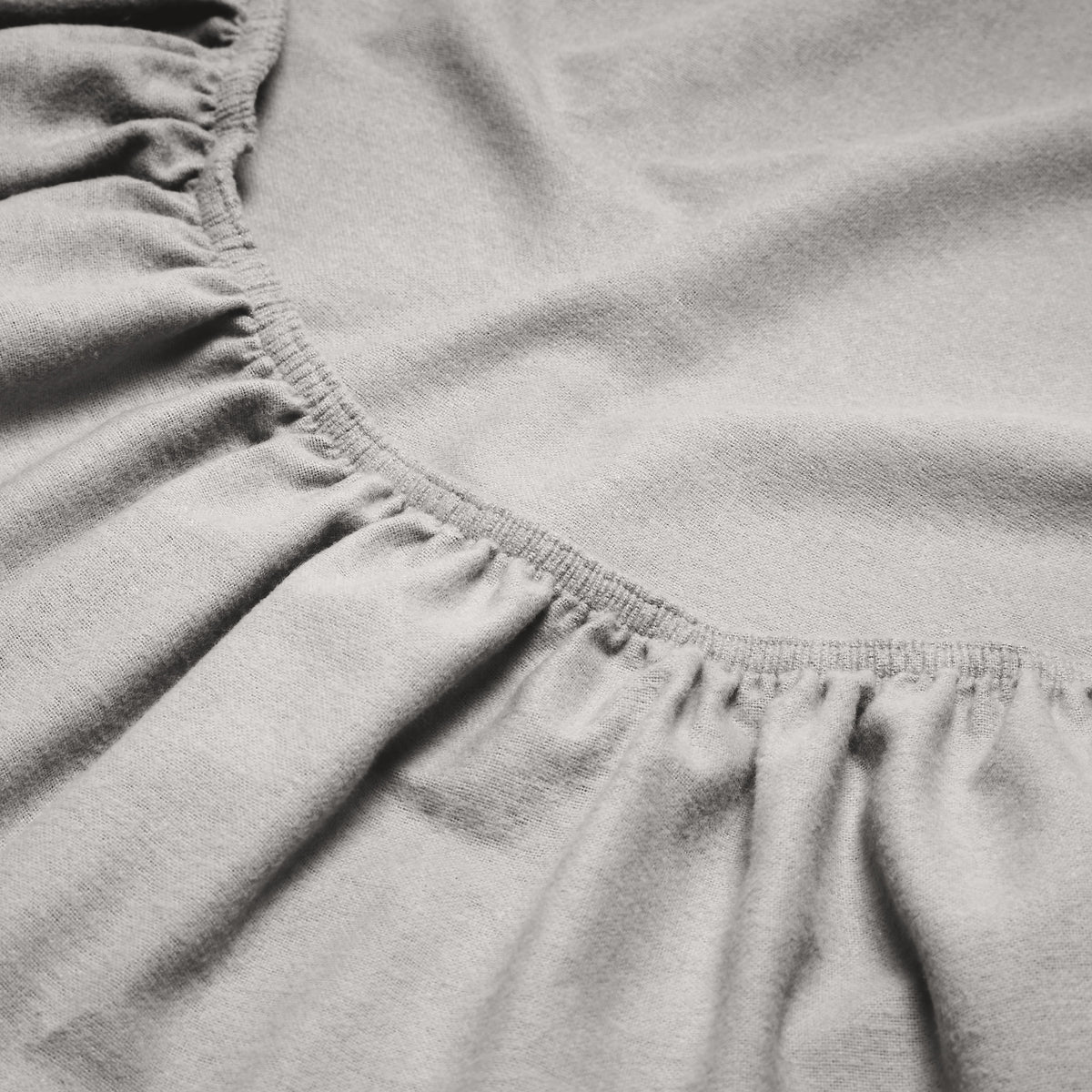 Close-up of a flannel fitted sheet with gathered elastic