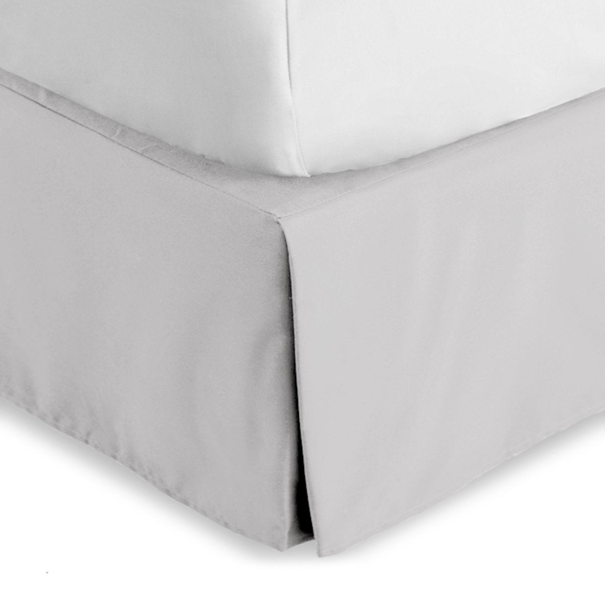 Bed skirt on a bed with white bedding