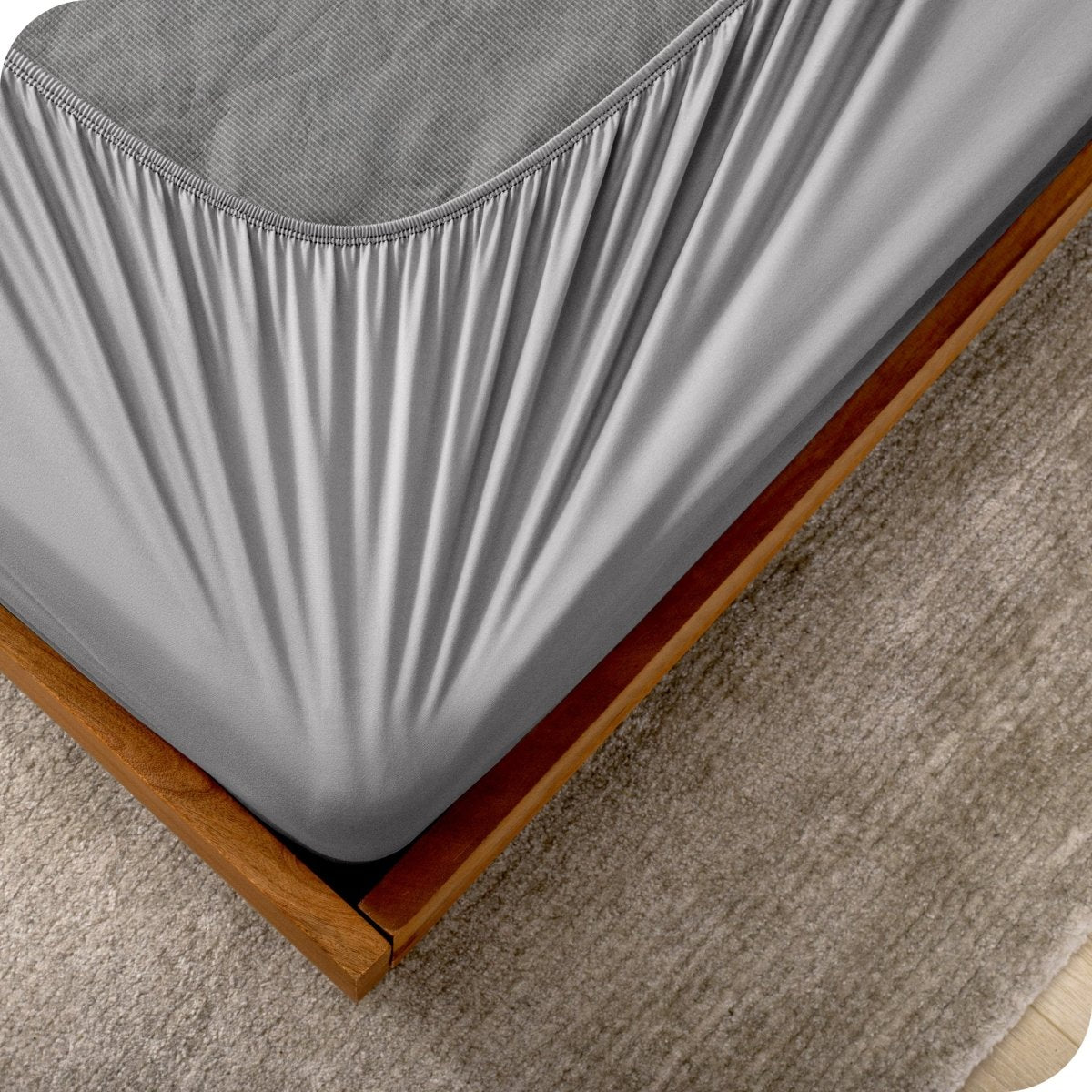 The corner of a box spring with a cover on it