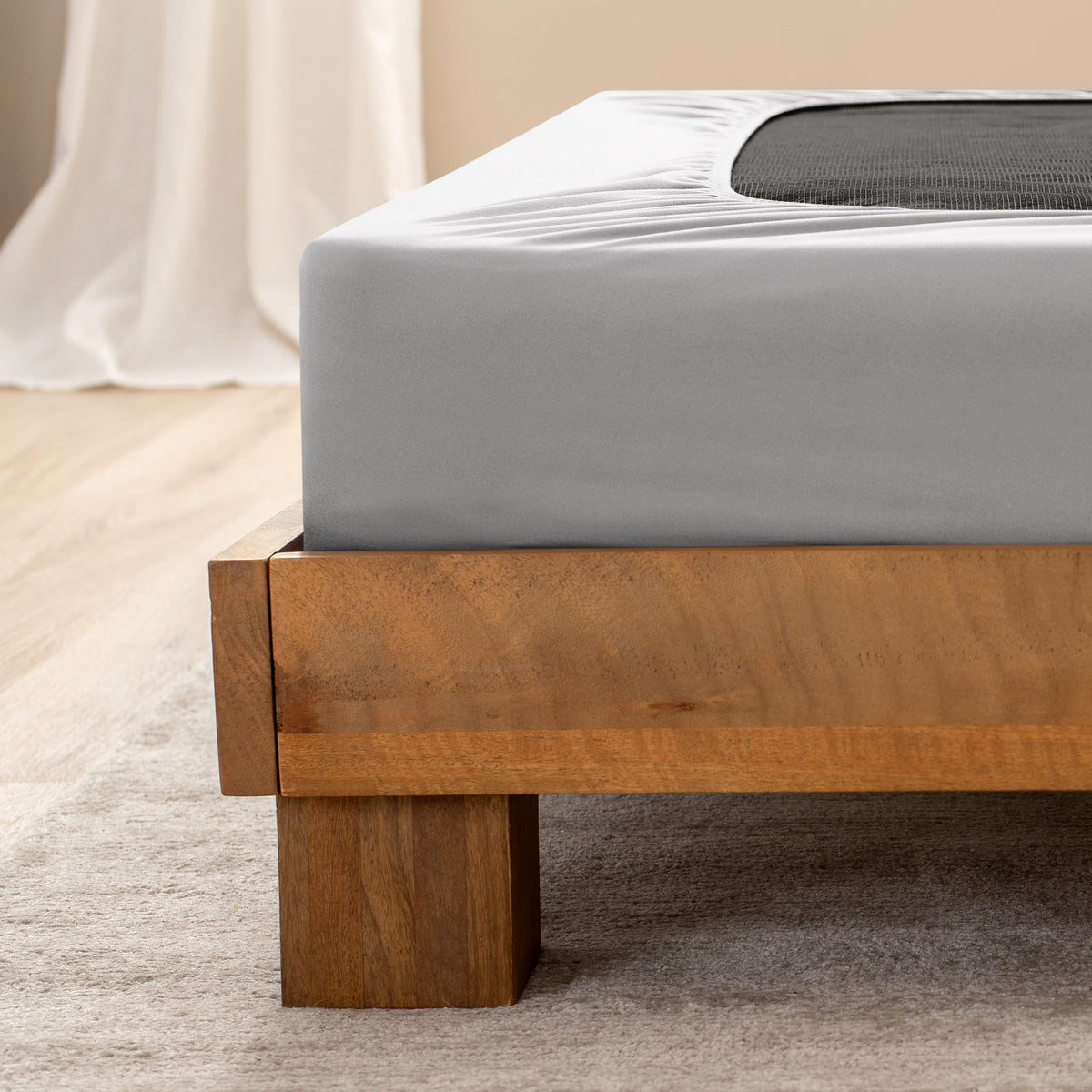 Close up of the corner of a bed frame with a cover box spring 