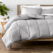 A modern bed with a down alternative comforter set on it