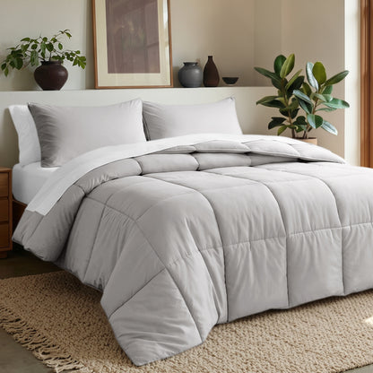 Comforter set on a bed in a bedroom with plants and decor.
