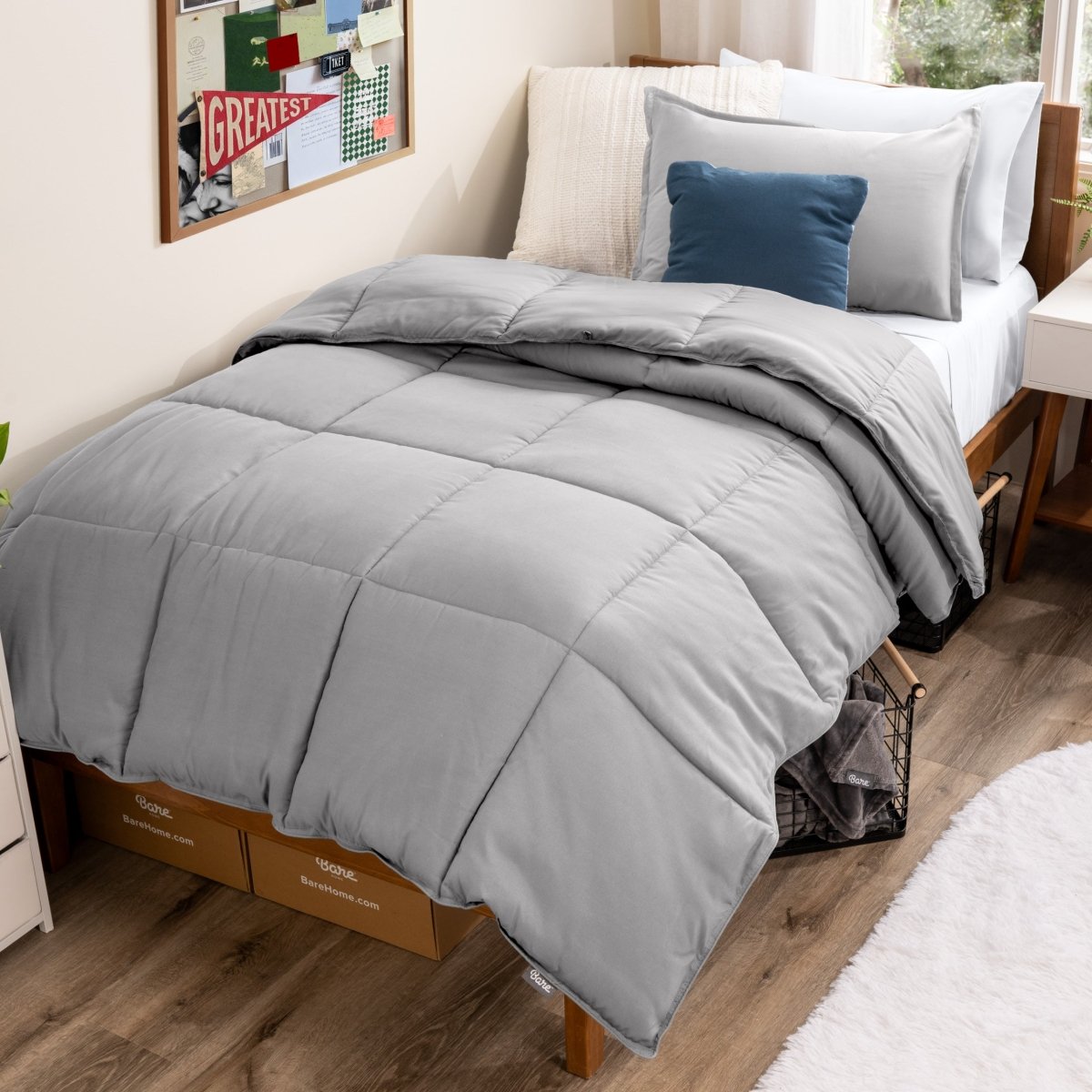 Bed with comforter and pillows in a dorm room