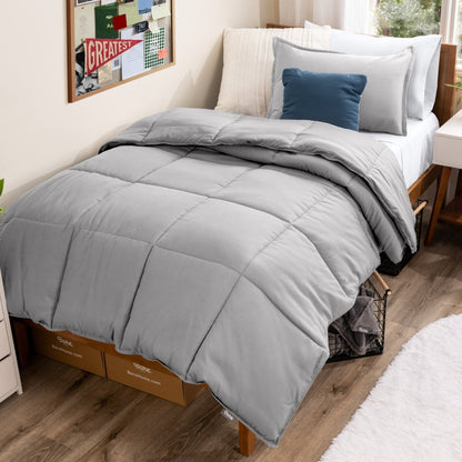 Bed with comforter and pillows in a dorm room