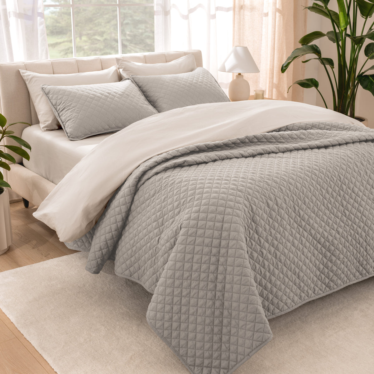 Bedroom showing coverlet set laying on the bed with the quilt folded over on itself