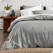 A modern bed with a microfiber duvet cover and sham set in light grey.