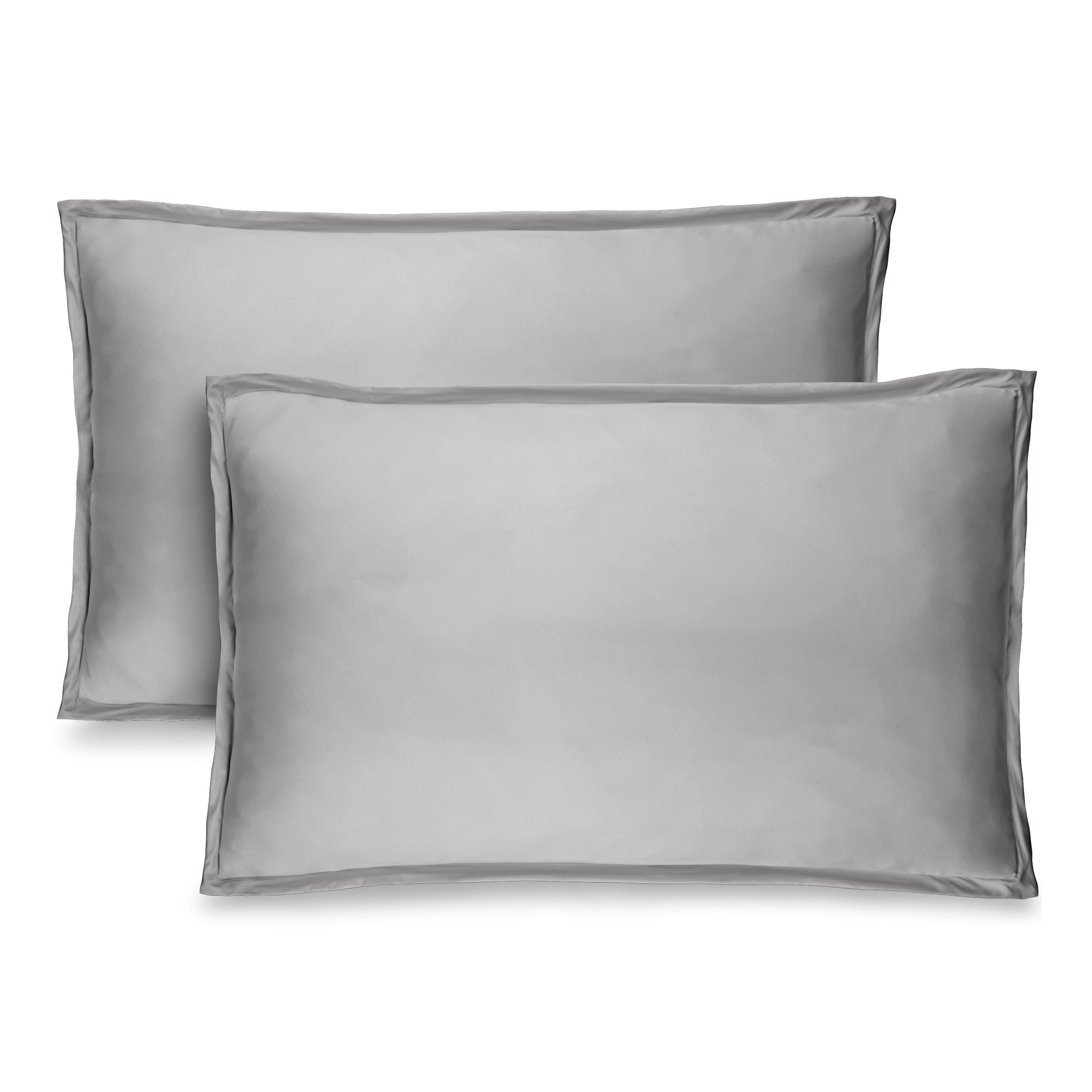 Two light grey pillow shams on pillows standing up with one behind the other