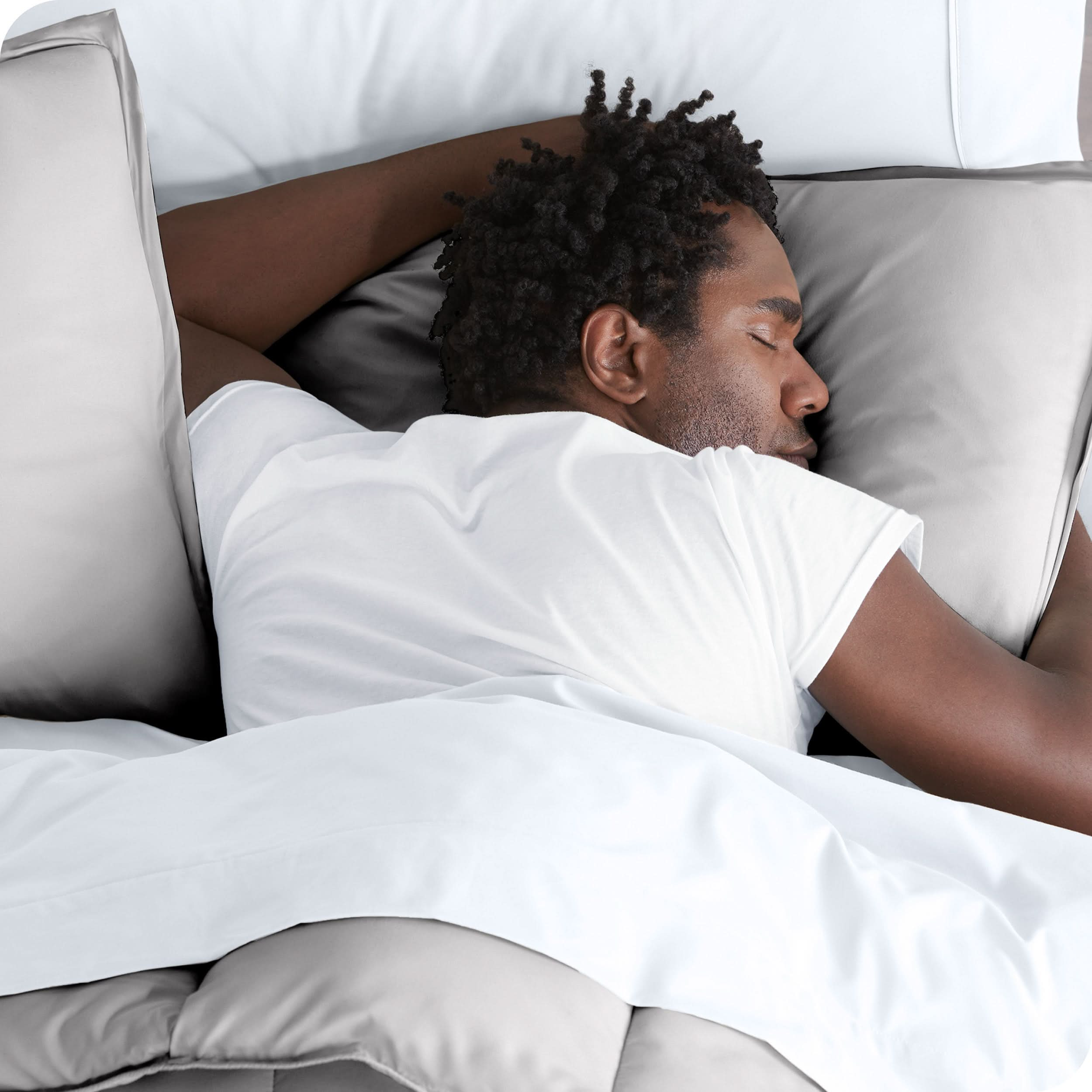 Man sleeping with his head resting on a pillow sham