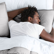 Man sleeping on a bed with microfiber bedding