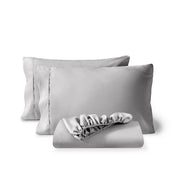 Pillowcases and a matching fitted sheet folded in front, shown on a plain white background.