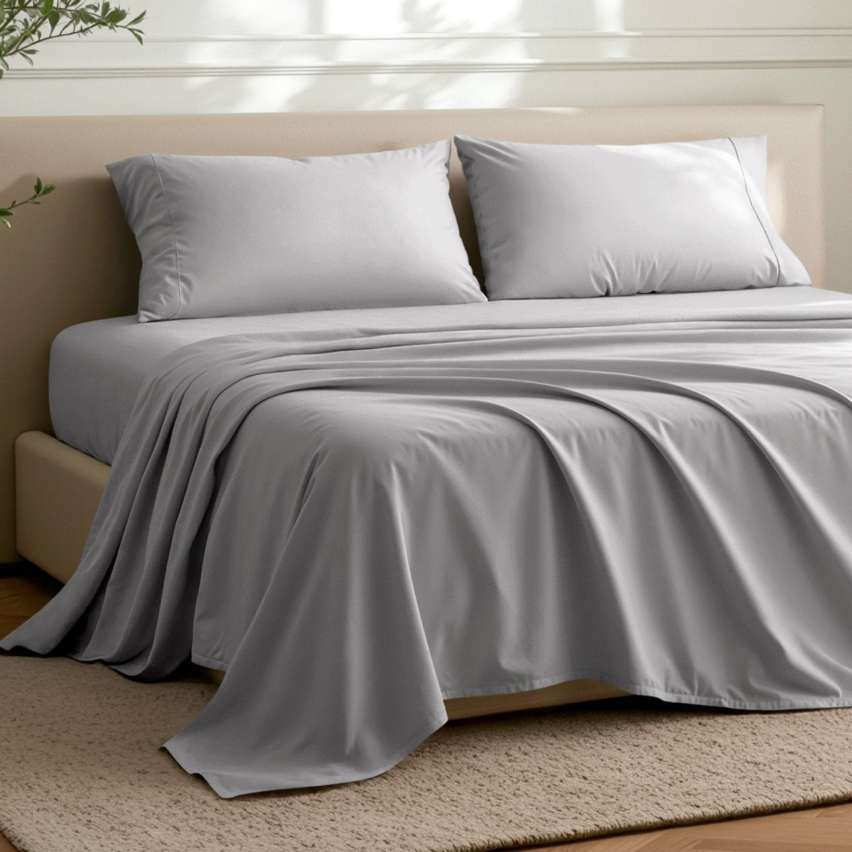 Microfiber flat sheet on a bed in a bedroom with a plant.