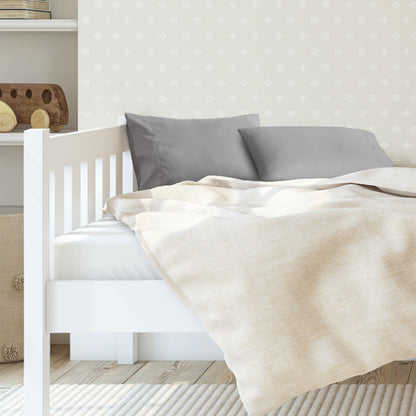 A toddler's bed with 2 microfiber pillowcases on pillows