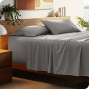 Bed with microfiber bedding and wooden headboard in a bedroom setting