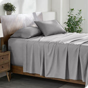 A cozy bedroom featuring a neatly made bed with soft, microfiber sheets.