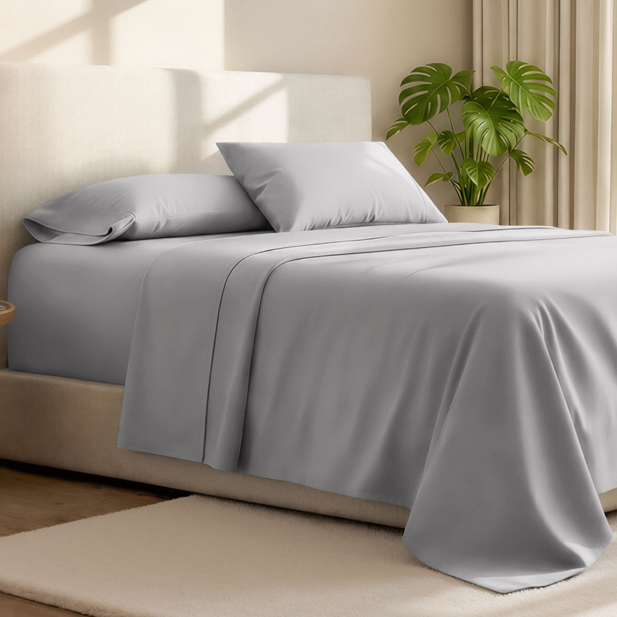 Microfiber bed sheets on a neatly made bed with a wooden headboard and nightstand.