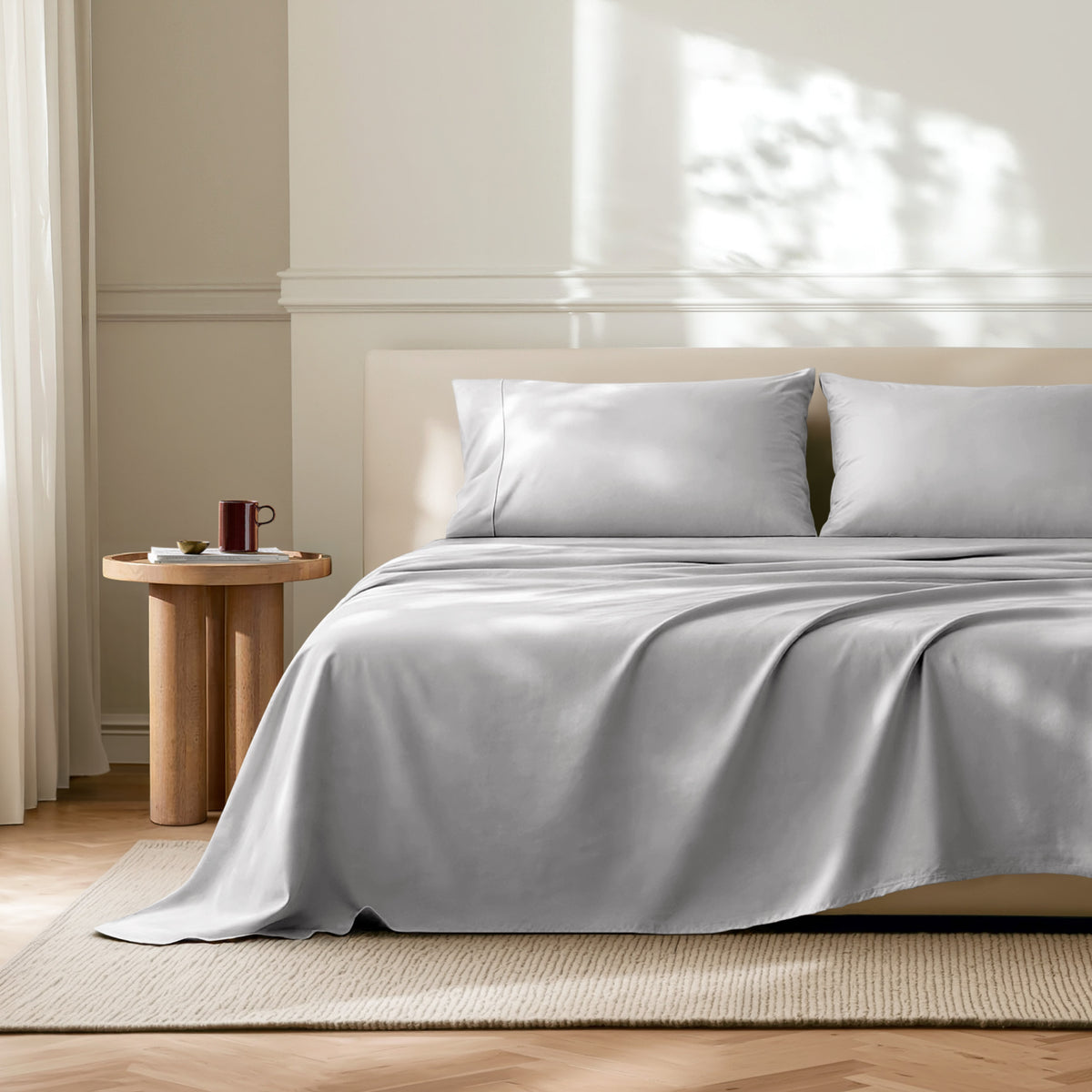 Neatly made bed with microfiber bedding in a bright bedroom.