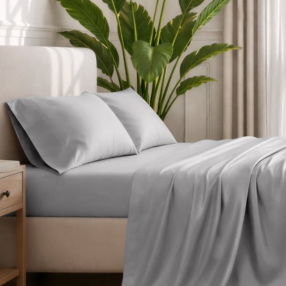 Ultra-soft sheets and pillowcases on a bed with a plant in the background