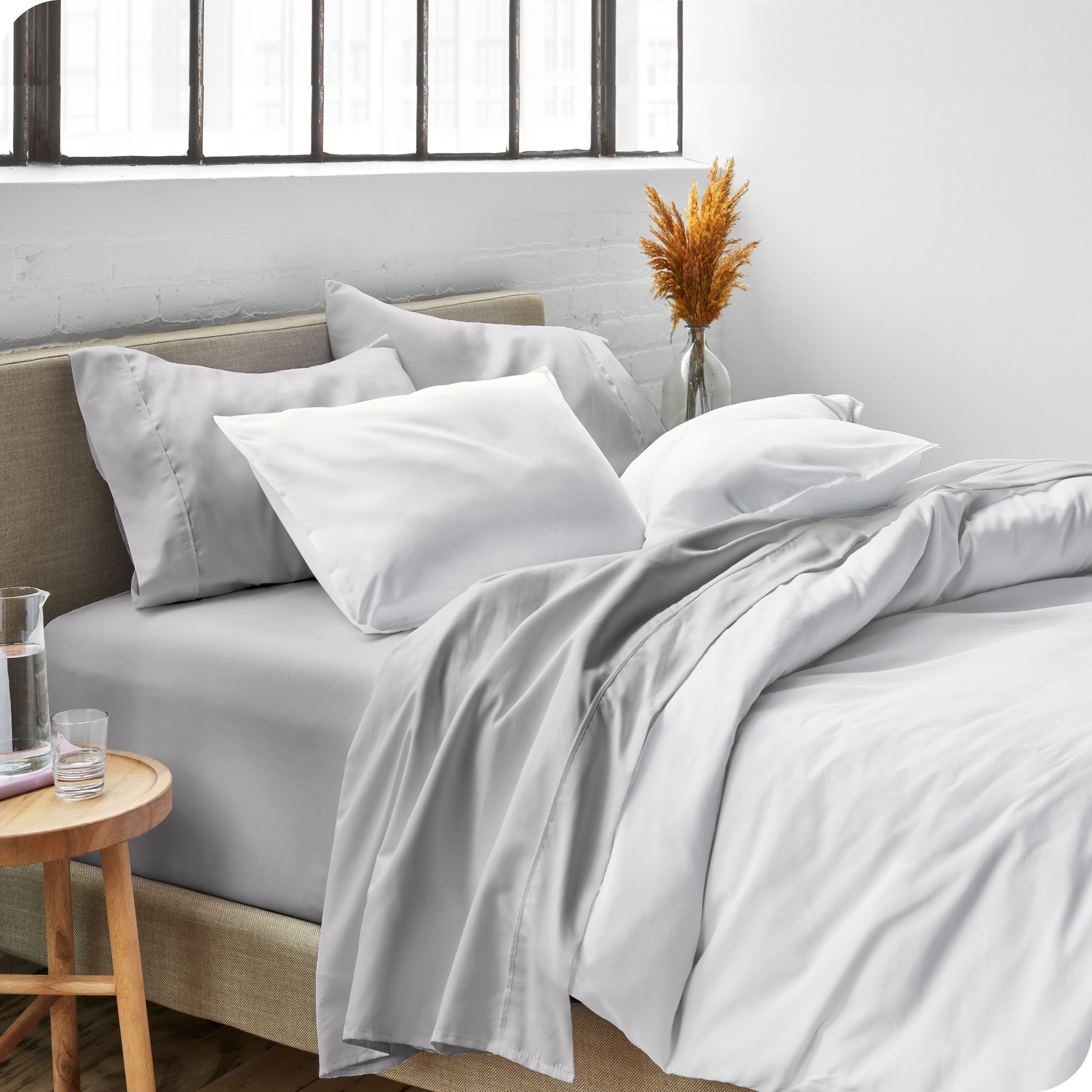 Sheets and a duvet cover on a bed in a bright bedroom