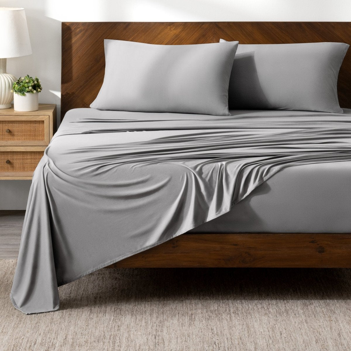 Bed sheets on a wooden bed in a bedroom setting