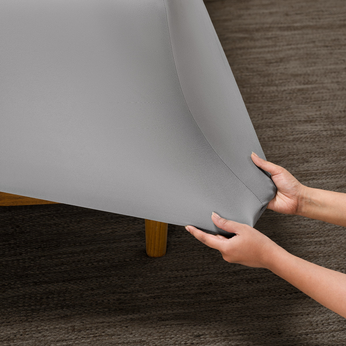 Person putting a microfiber stretch fitted sheet on a mattress