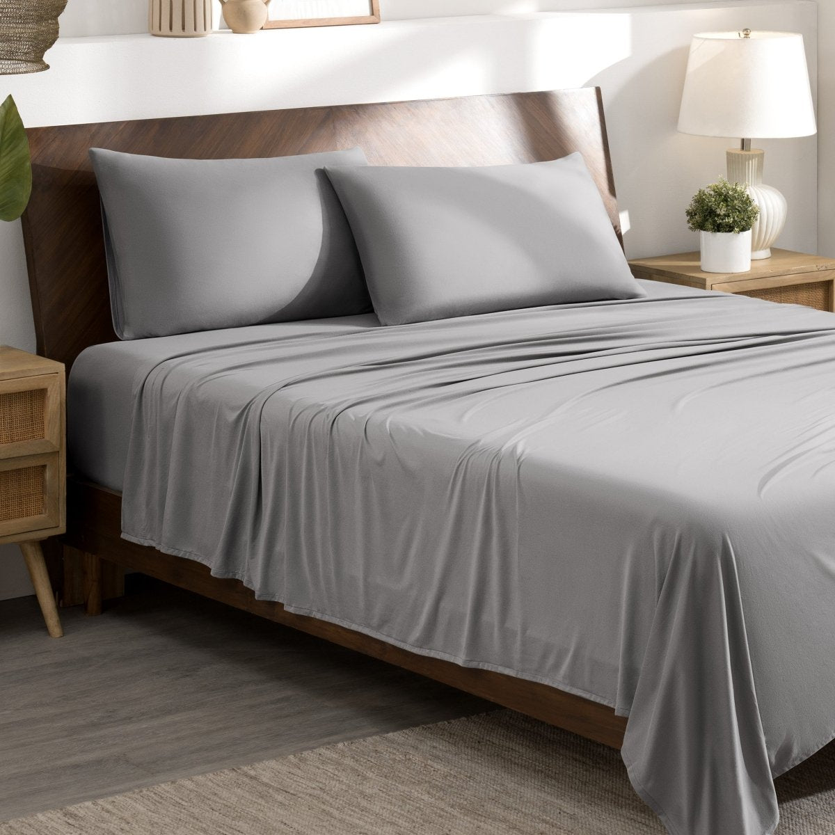 Bed sheets and pillows on a bed in a bedroom setting.