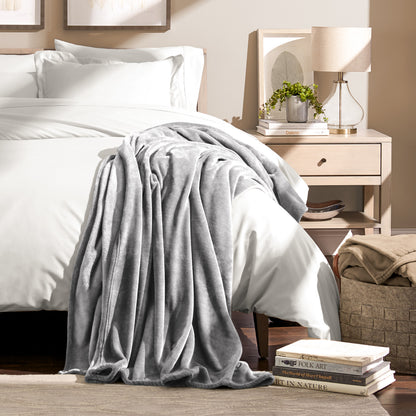 Microplush blanket draped over the corner of a bed