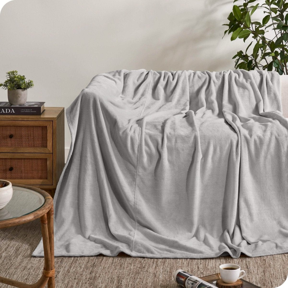 A giant microplush blanket draped over a couch