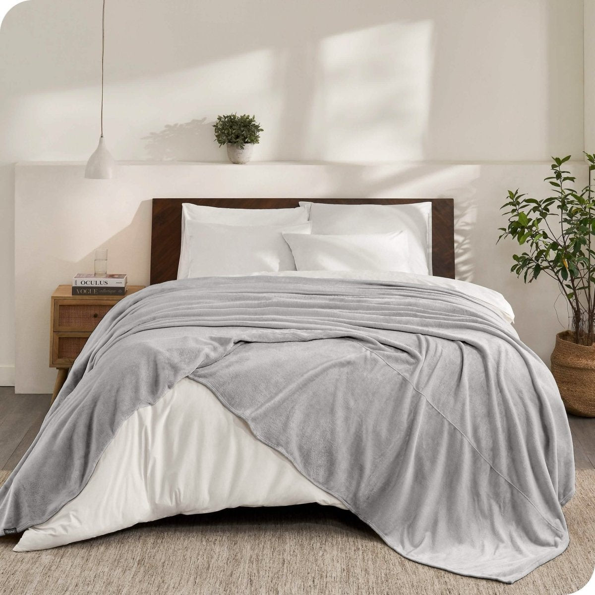 An oversized microplush blanket draped over a bed