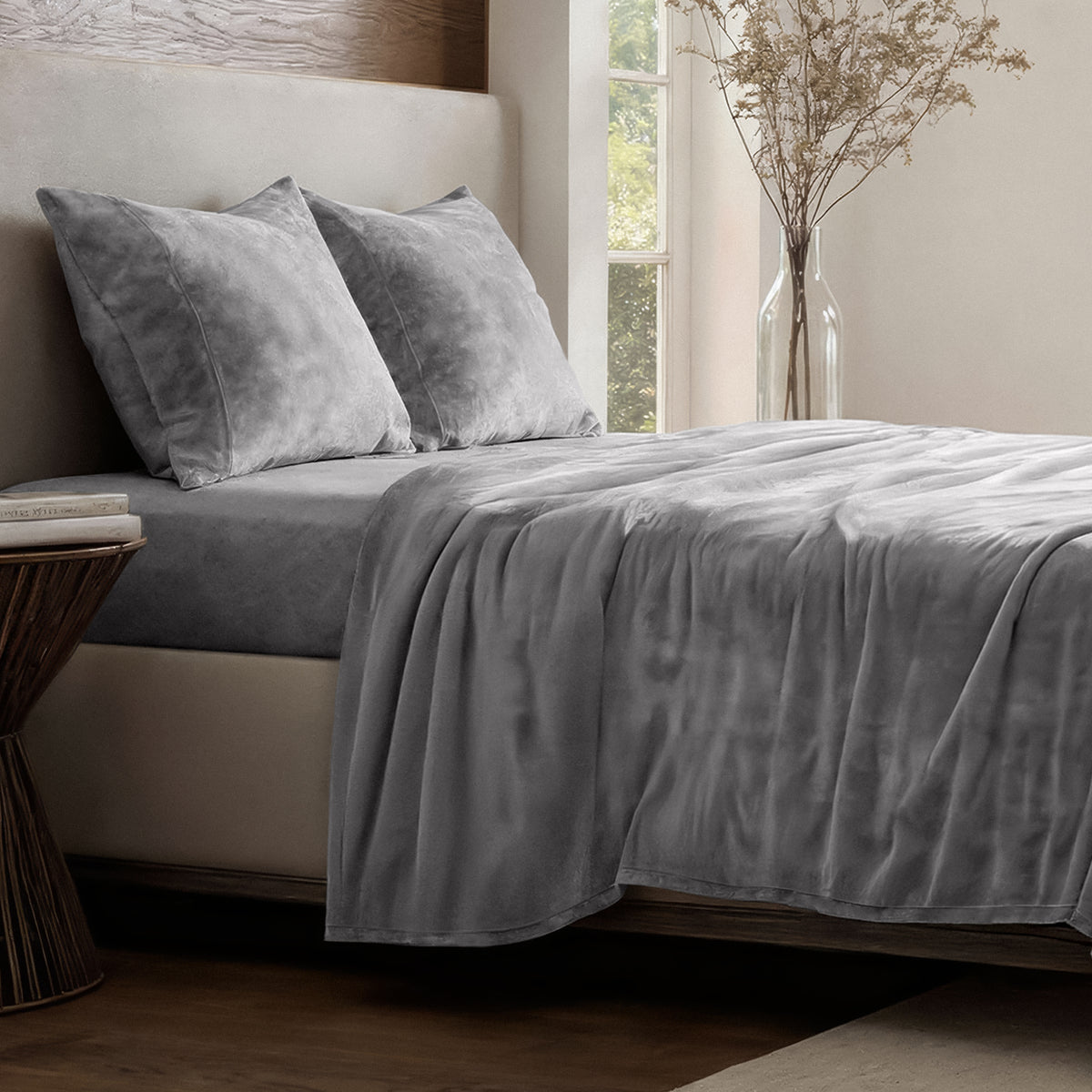 Neatly made bed in a well-lit bedroom.