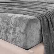 Close-up of the corner of a bed made with microplush sheets
