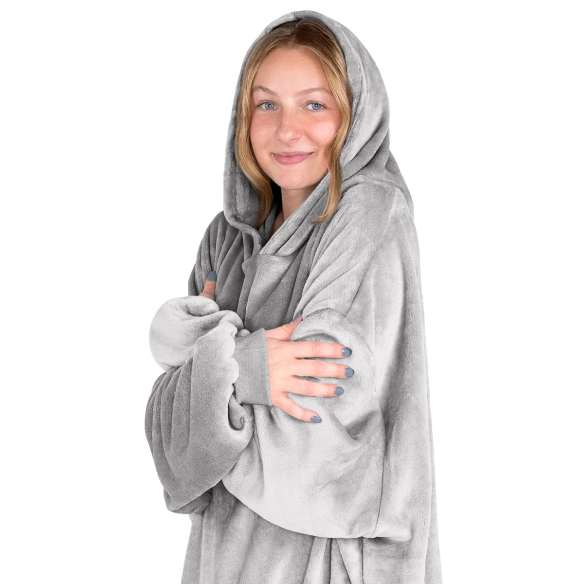 A woman is snuggled up in microplush wearable blanket