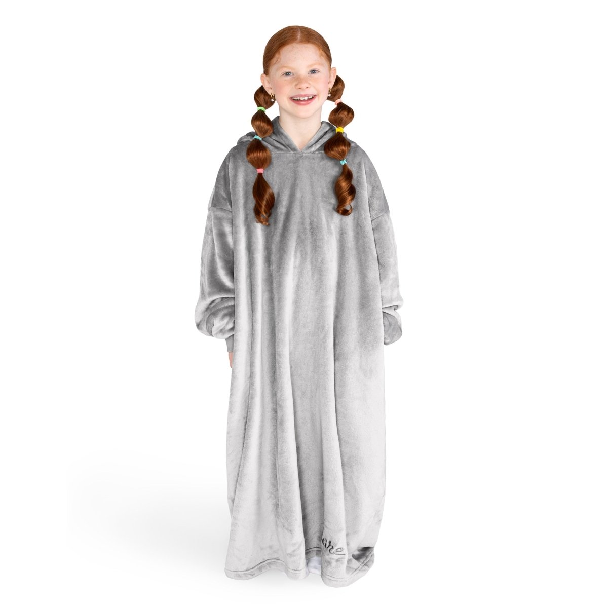 A girl is standing while wearing a long microplush wearable blanket