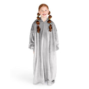 A girl is standing while wearing a long microplush wearable blanket