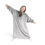 A girl has a hooded blanket on that is long enough to cover her legs