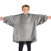 A boy wearing a blanket made of microplush, showcasing comfort and warmth.