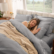 Woman sleeping on a bed made with percale sheets and duvet cover