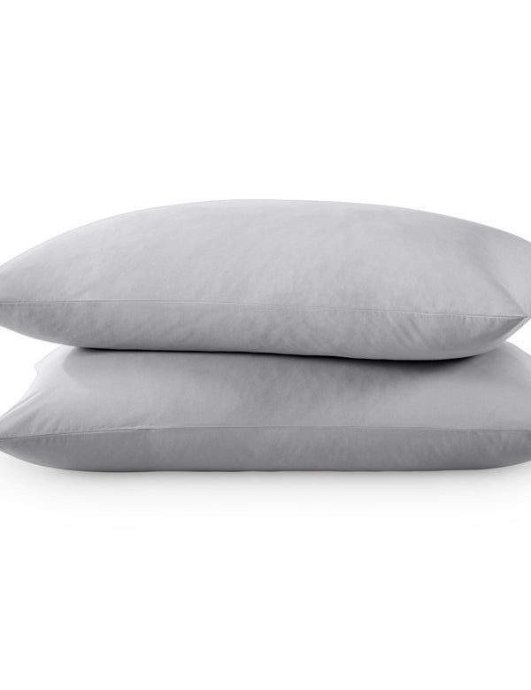 Two pillows with percale pillowcases on them