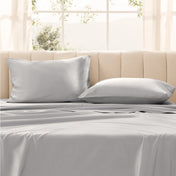 Pillows on a bed with in a bright room.