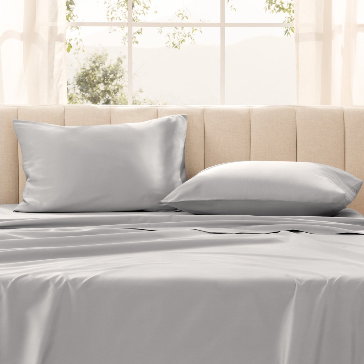 Pillows on a bed with in a bright room.