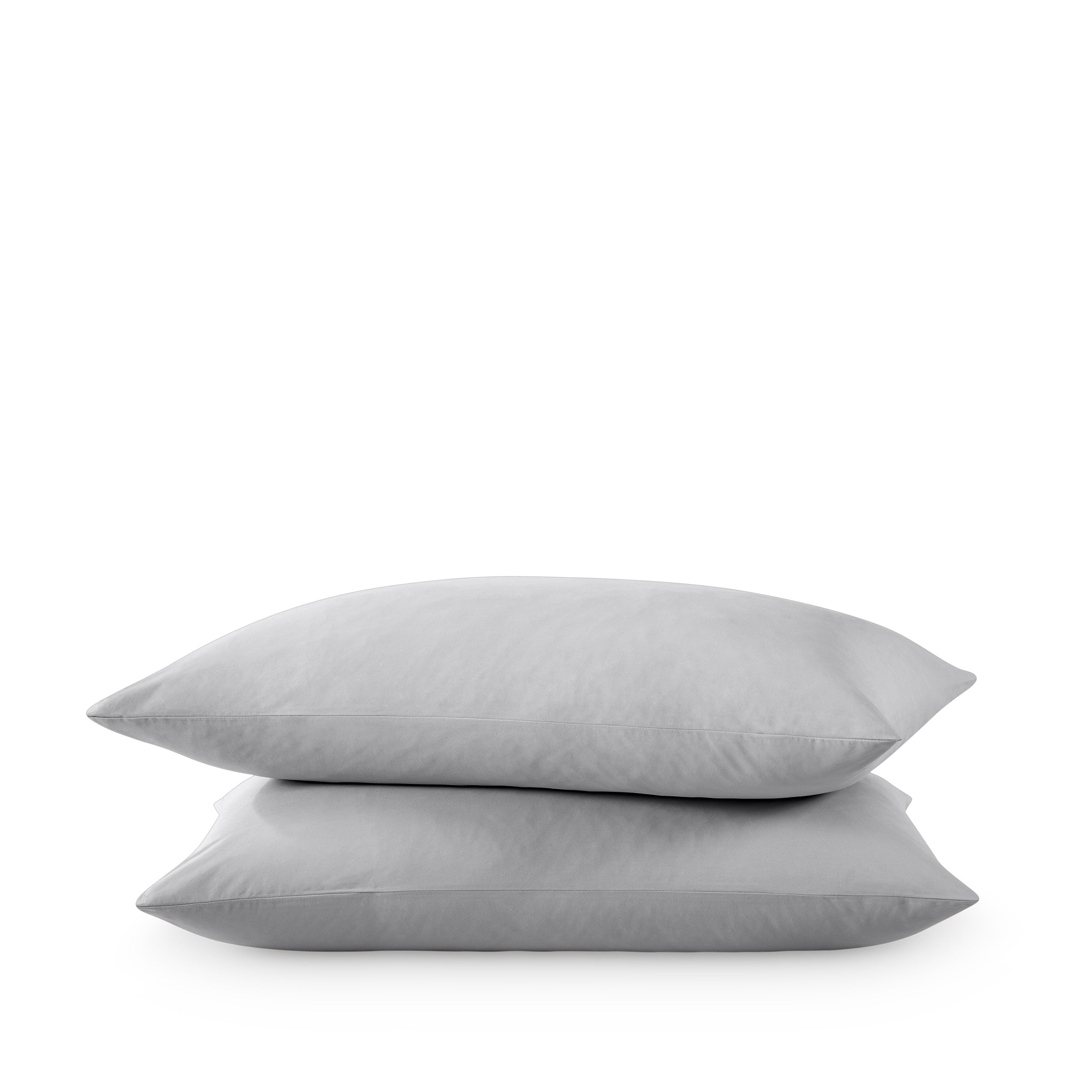 Two pillows stacked on a white background
