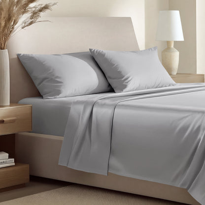 Sateen bedding set including a fitted sheet and two matching pillowcases on a bed.