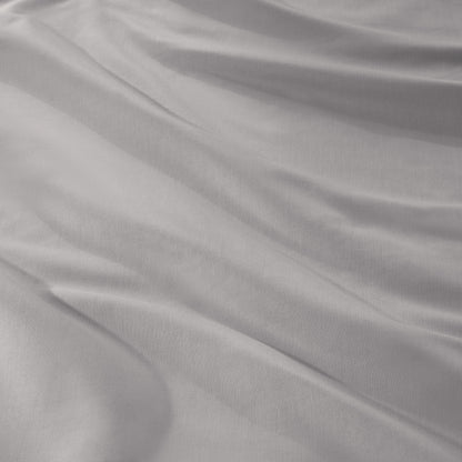 A close-up of draped sateen fabric with soft folds and a smooth texture.