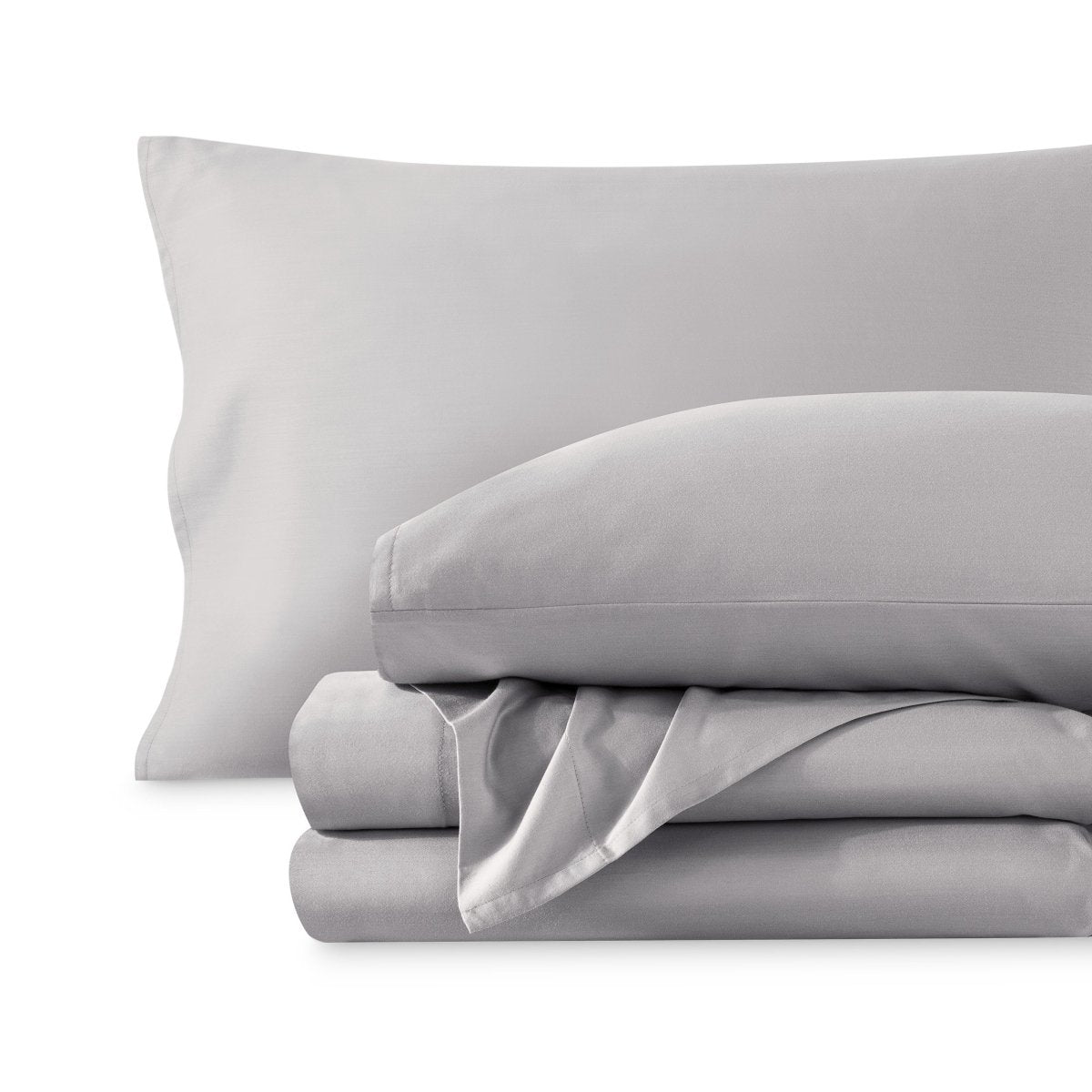 A sateen sheet set folded and stacked on a white background.
