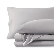 A sateen sheet set folded and stacked on a white background.