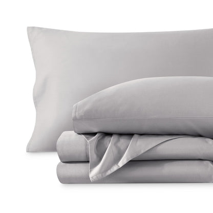 A sateen sheet set folded and stacked on a white background.