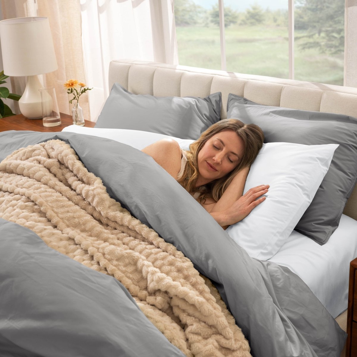 Woman sleeping in a bed with percale bedding