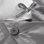 White fitted sheet on a bed with a close-up of folded white sheet below