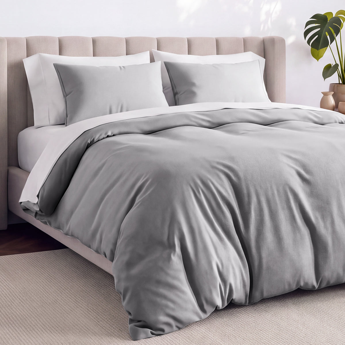 Bed with jersey duvet set against a beige headboard.