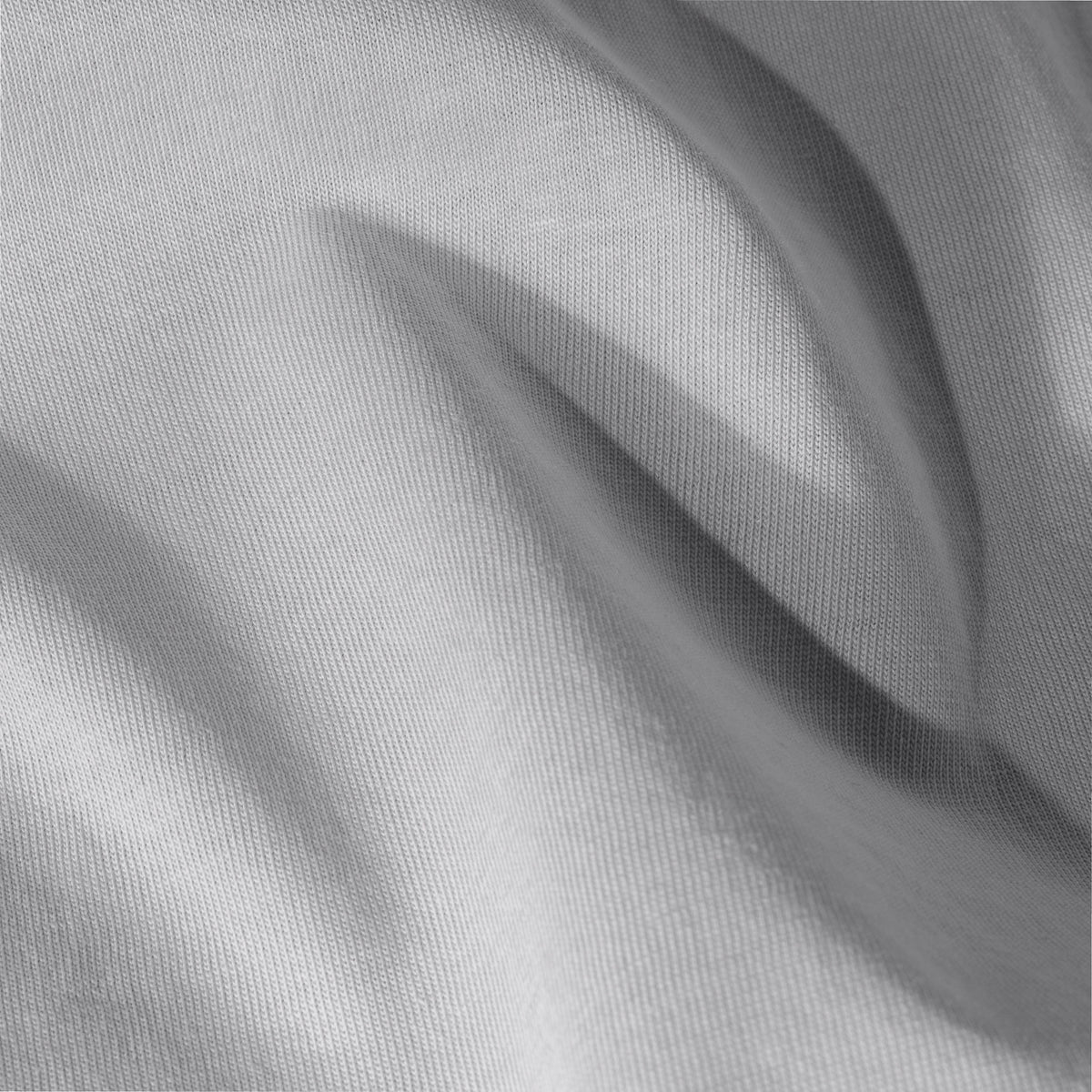 Close-up of jersey fitted sheet fabric with visible texture